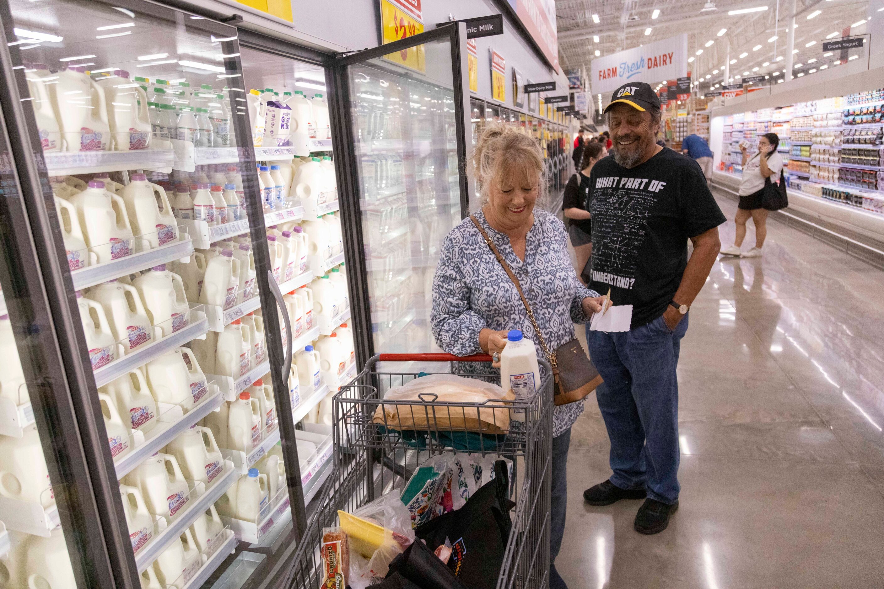 Customers Taffy Delgado (left) and Ruben Delgado of McKinney shop the dairy section during...