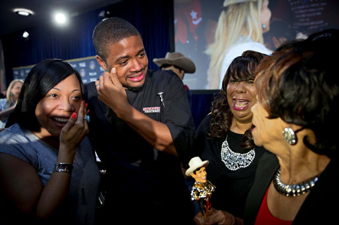 Brent Reaves (second from left) and family react after he and his team won "Best Taste" for...