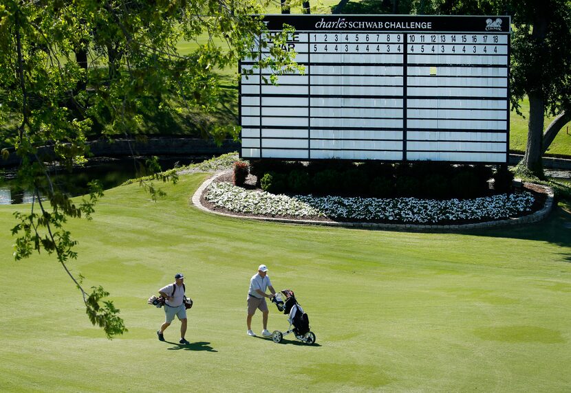 Here, Colonial Country Club members Roger Lee (left) and Chris Minor walk up the 18th...