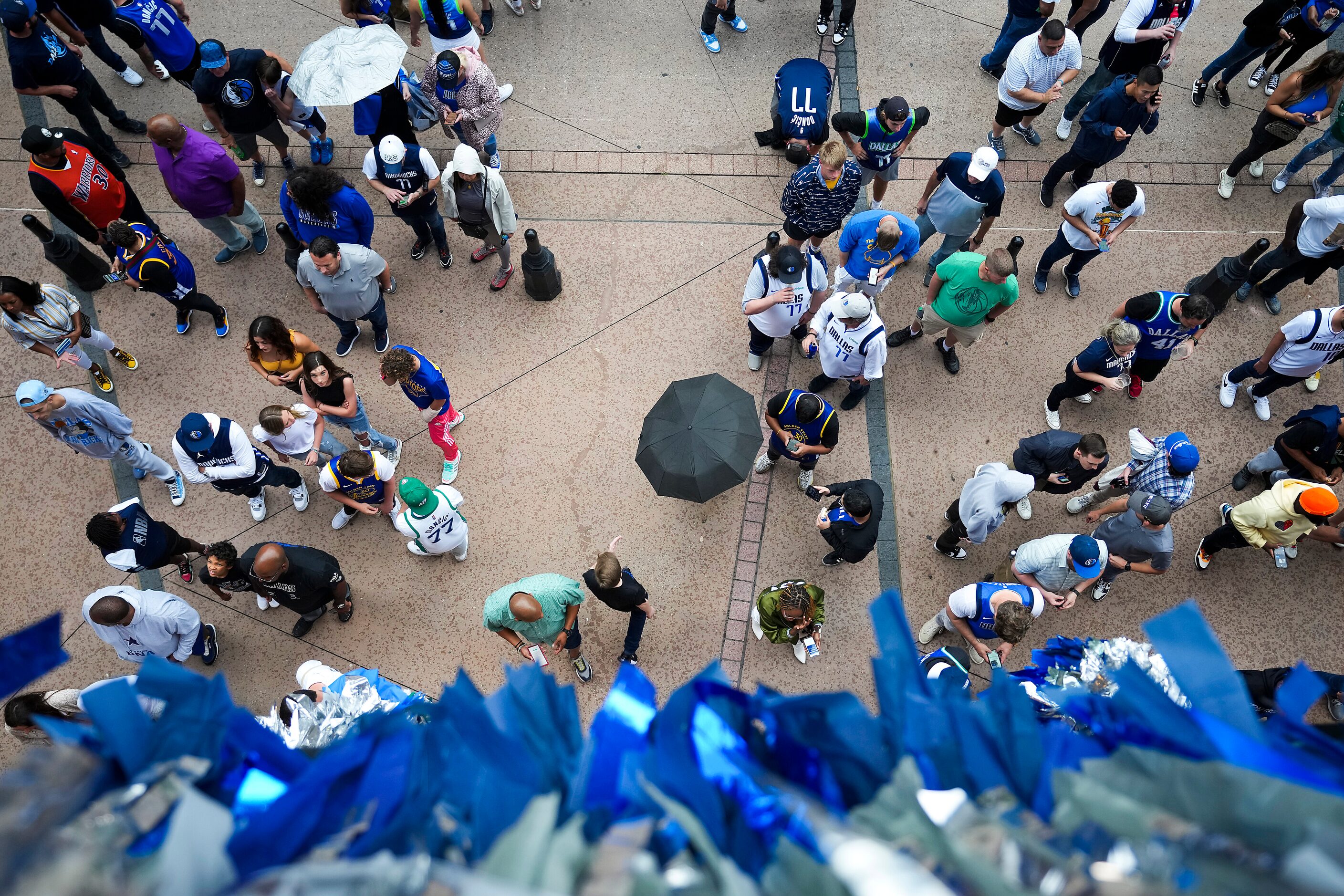 Fans wait in a light rain to enter the arena before Game 4 of the NBA Western Conference...