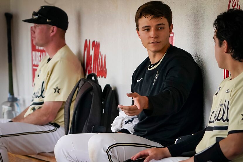 Vanderbilt pitcher Jack Leiter talks with catcher CJ Rodriguez in the dugout during an NCAA...