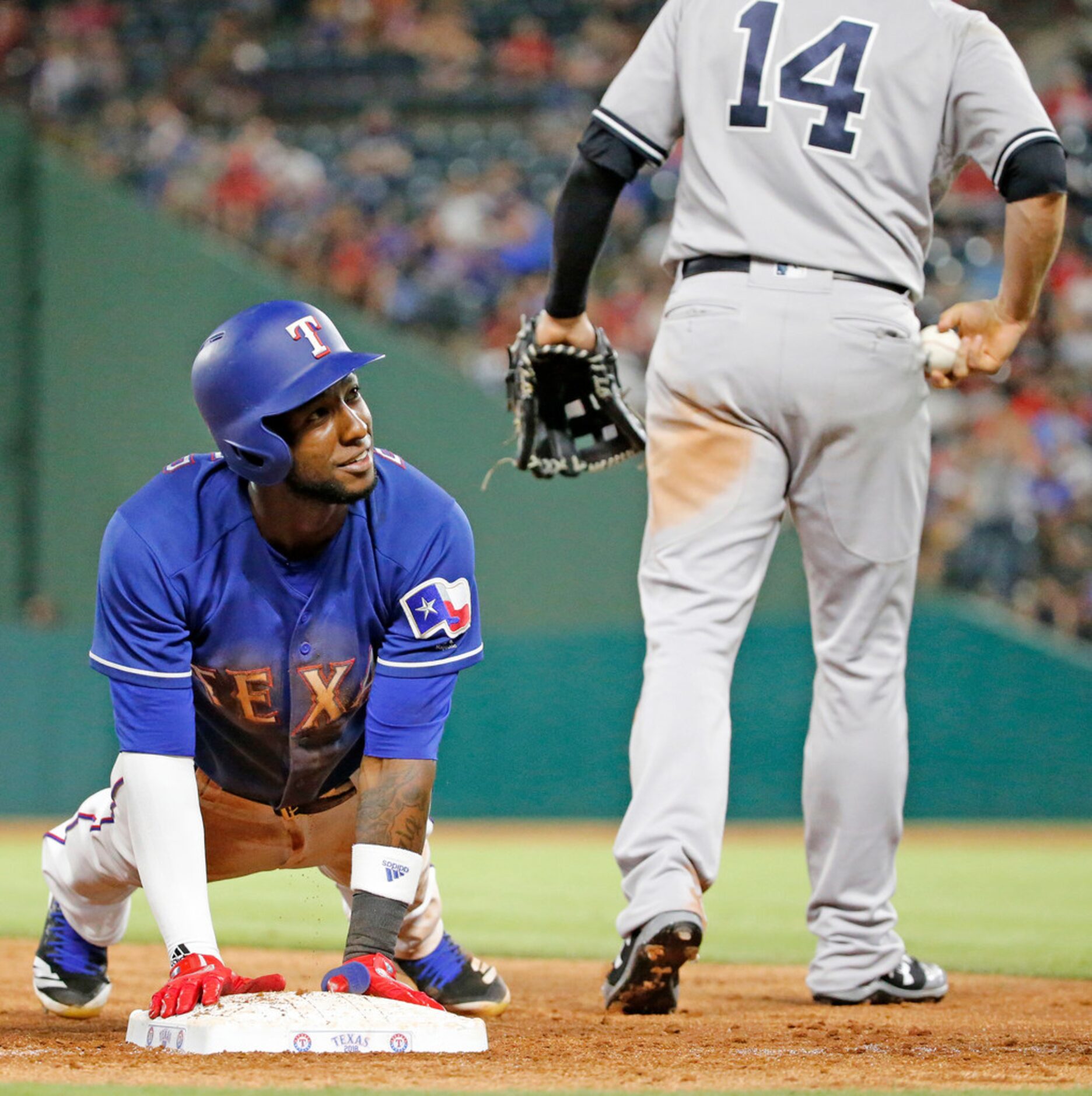 Texas Rangers shortstop Jurickson Profar (19) advances to third on a fly ball out in the...