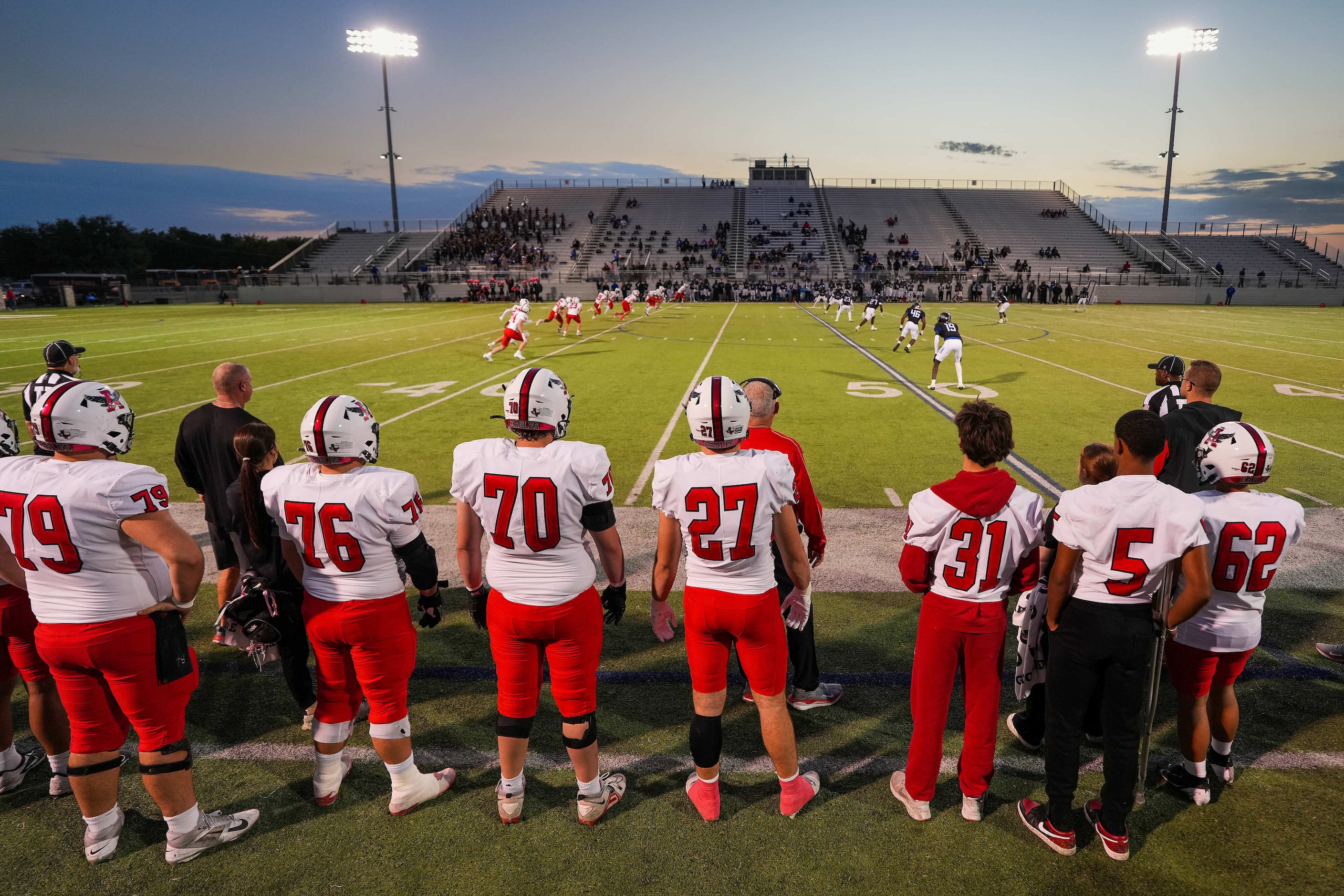 Players on the Argyle bench watch the kickoff of a District 3-5A Division II high school...