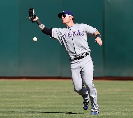 Texas center fielder Josh Hamilton drops an easy fly ball that would have ended the fourth...