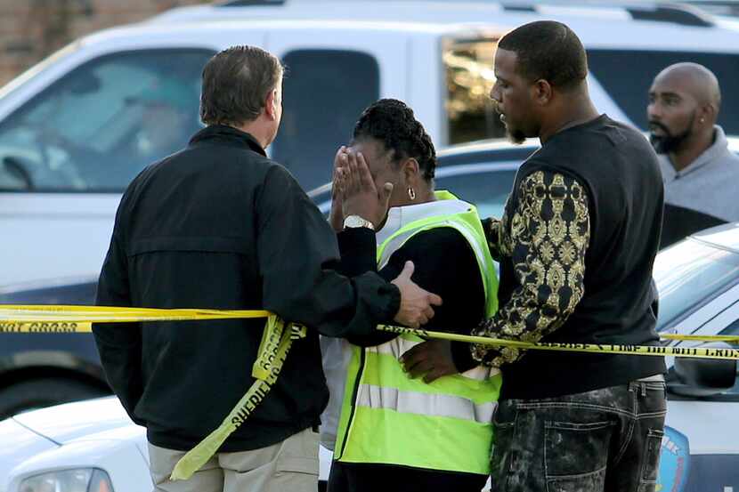 Jefferson Parish Sheriff Newell Normand consoles a woman at the scene of former NFL player...
