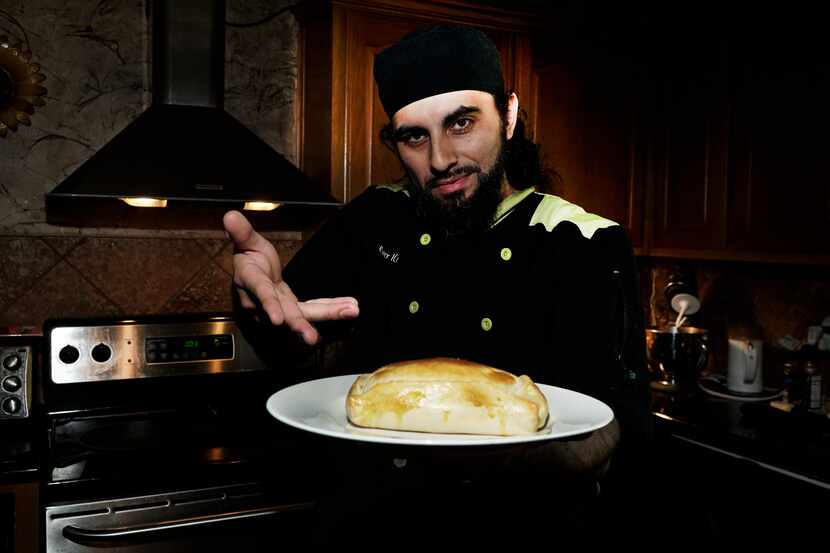 Local chef and hip-hop DJ Julio Cordonnier poses with an empanada at his home in Euless.