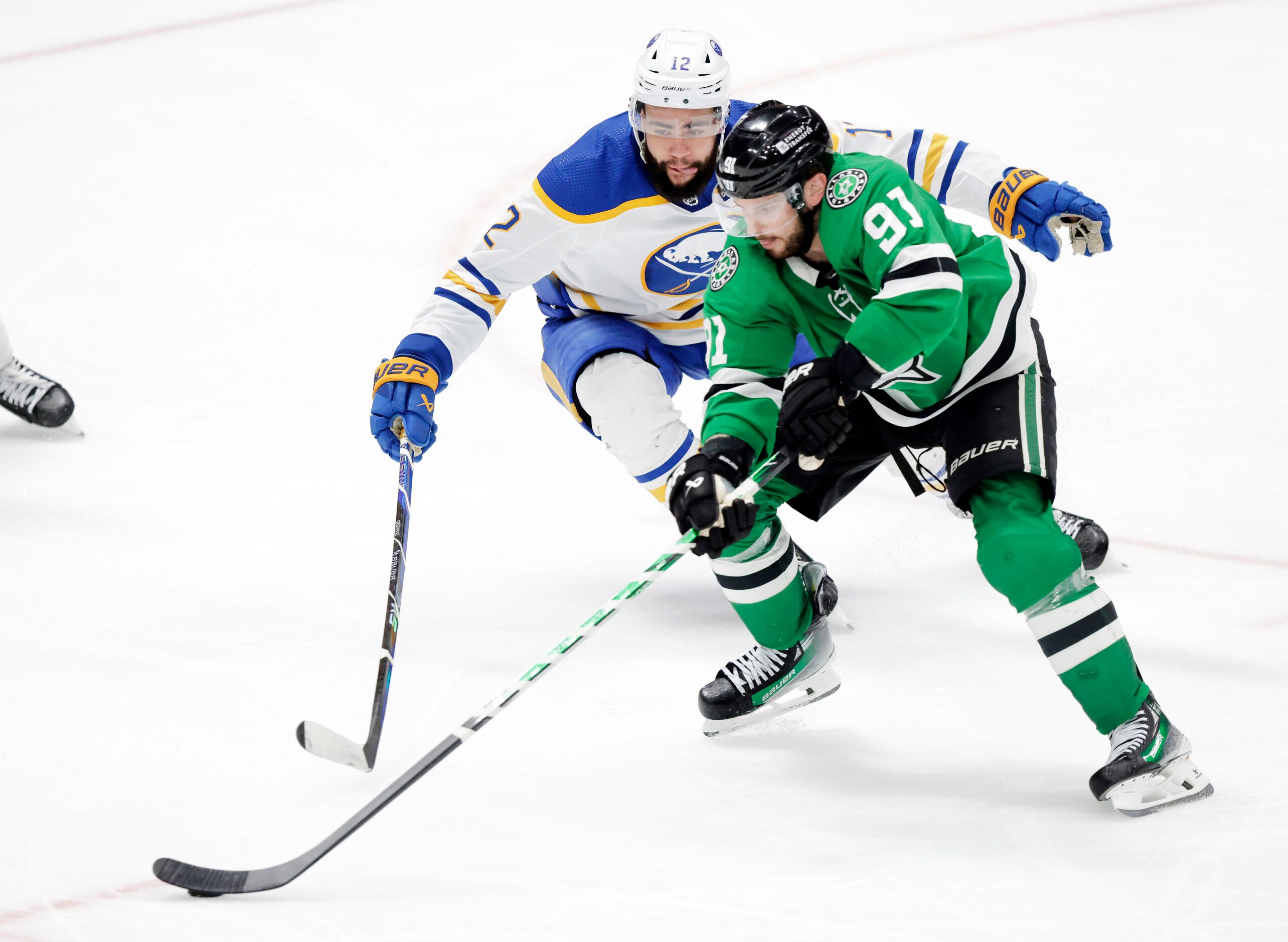 Dallas Stars center Tyler Seguin (91) keeps the puck from Buffalo Sabres left wing Jordan...