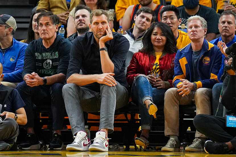 Dallas Mavericks owner Mark Cuban and former player Dirk Nowitzki watch from the front row...