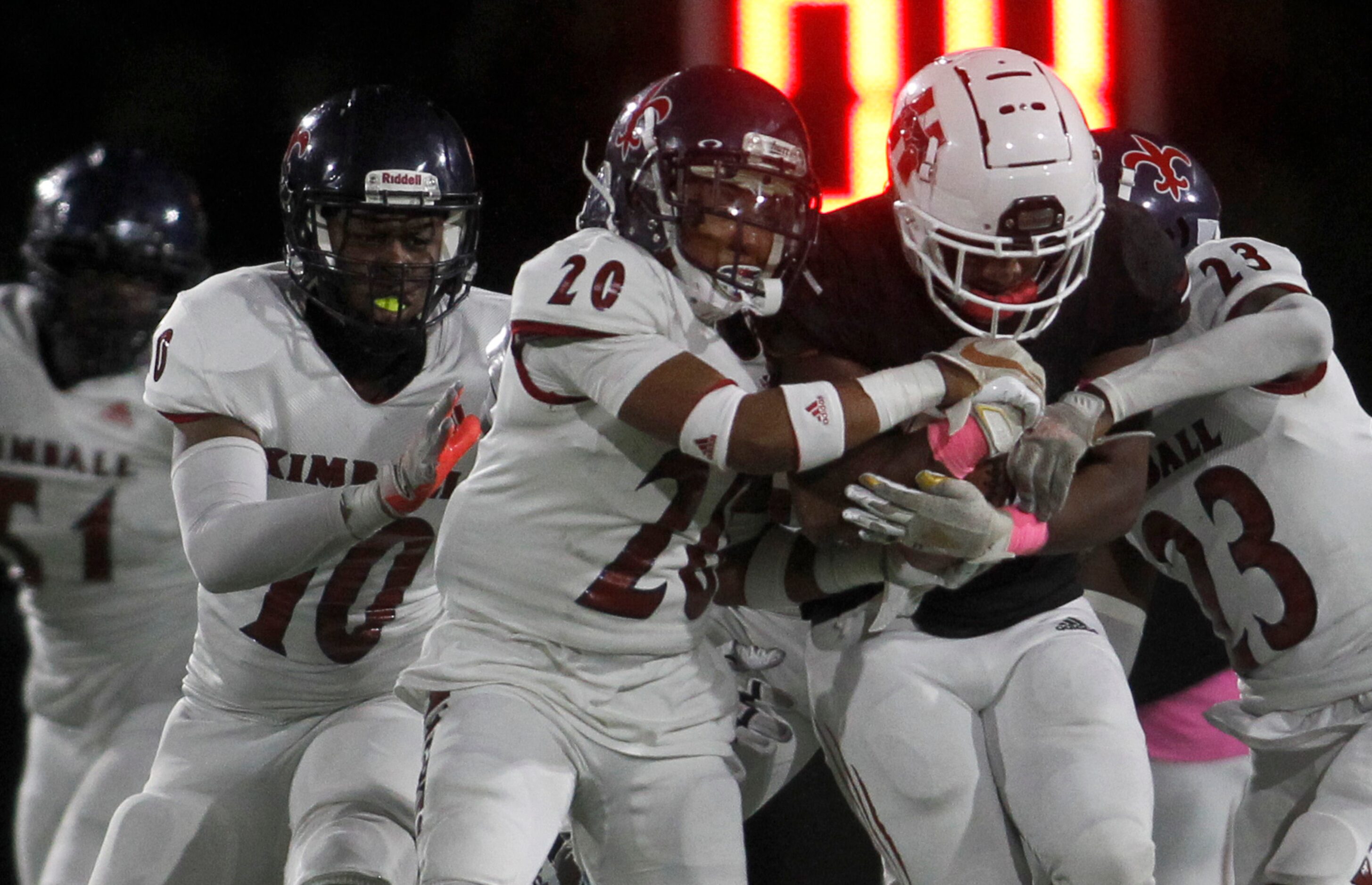 Dallas Hillcrest running back Oscar Humphrey (22) draws a crowd of Hillcrest defenders...