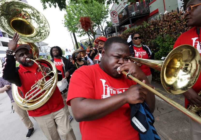 The Big Easy Brass Band leads a procession down Live Oak Street in Old East Dallas during...