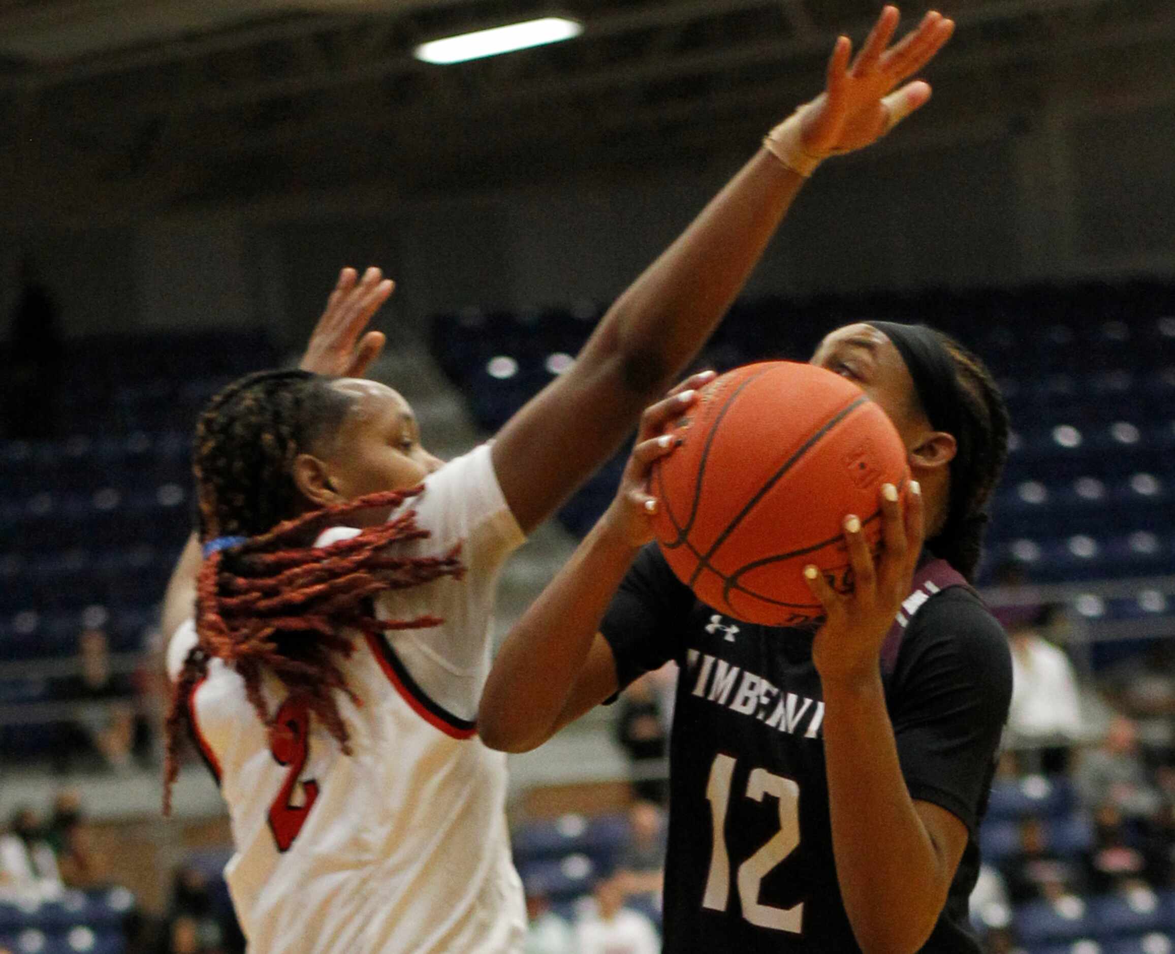 Mansfield Timberview point guard Crishawn Coleman (12) looks to shoot against the defense of...