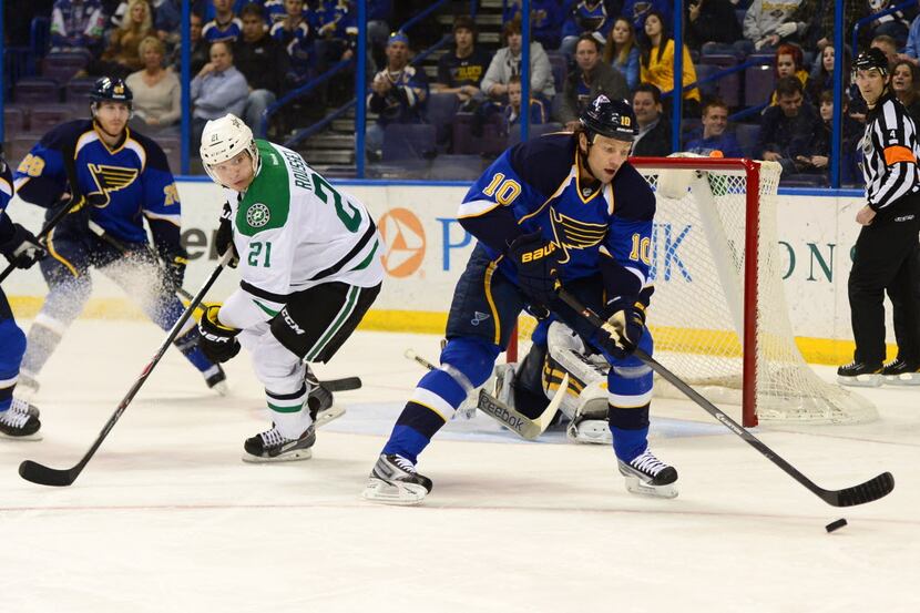 Mar 11, 2014; St. Louis, MO, USA; St. Louis Blues left wing Brenden Morrow (10) controls the...