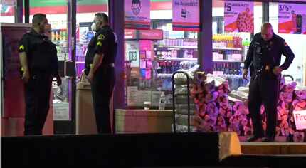 Police investigate the site of a fatal shooting at a 7-Eleven in the 3600 block of Forest...