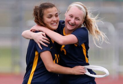 Highland Park team captain Presley Echols (10) is embraced by Keller Matise (6) after Echols...