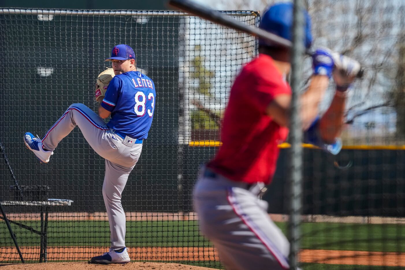 Pitcher Jack Leiter throws live batting practice to outfielder Bubba Thompson during a Texas...