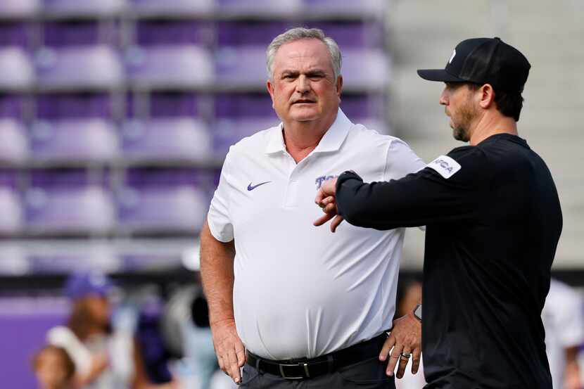 TCU head coach Sonny Dykes, left, is seen during a warming up session before an NCAA college...