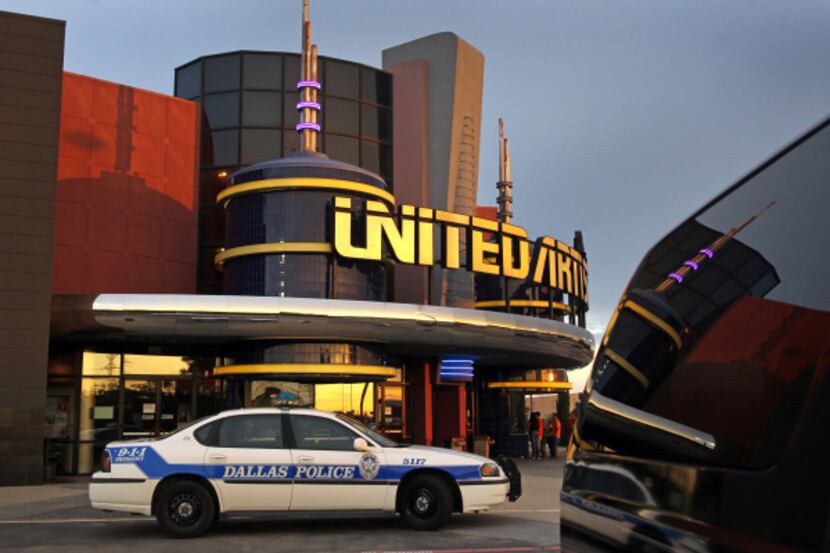 A police car sat Friday outside the United Artists Galaxy Theatre off LBJ Freeway in...