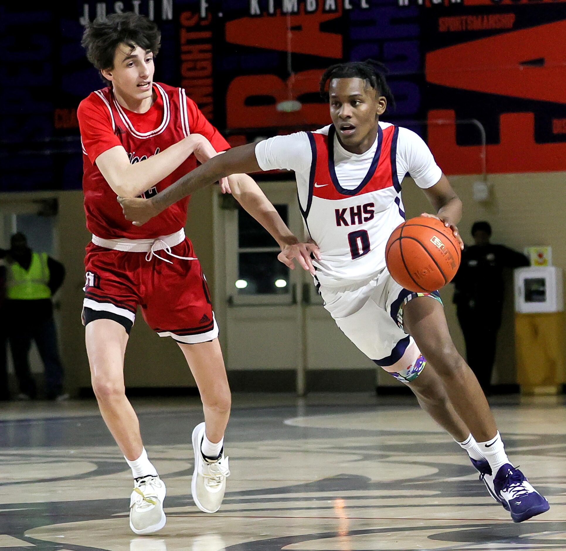 Kimball guard R.J. Osborne (0) tries to dribble past Woodrow Wilson forwrard Jackson...