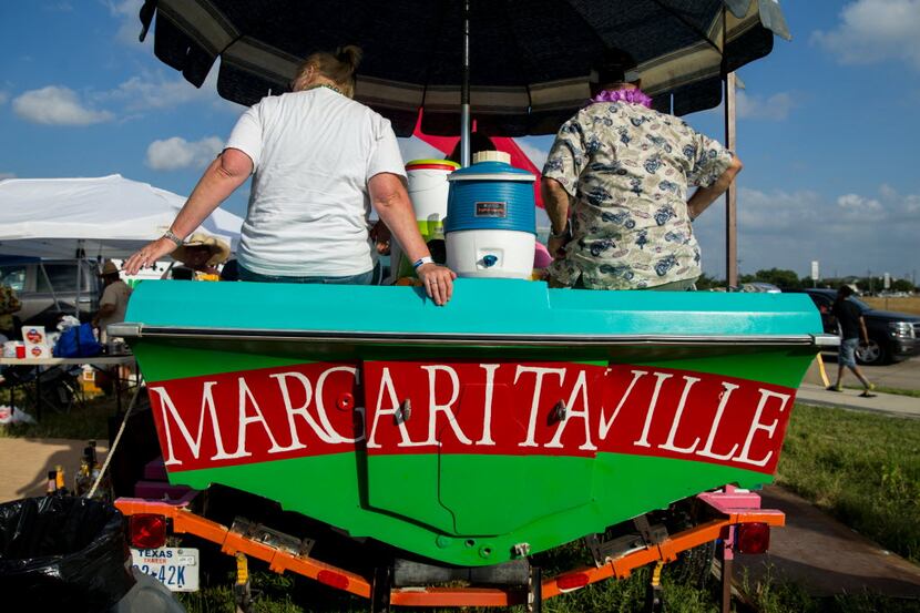 People tailgates on a boat owned by Charles Gillespie, of Bluffdale, Texas parked outside of...