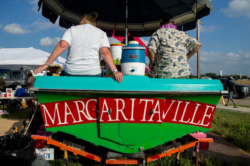 People tailgates on a boat owned by Charles Gillespie, of Bluffdale, Texas parked outside of...