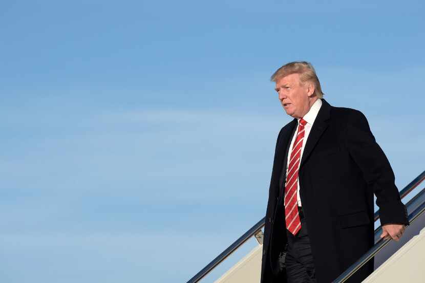 President Donald Trump walks off of Air Force One at Andrews Air Force Base in Md., Monday,...