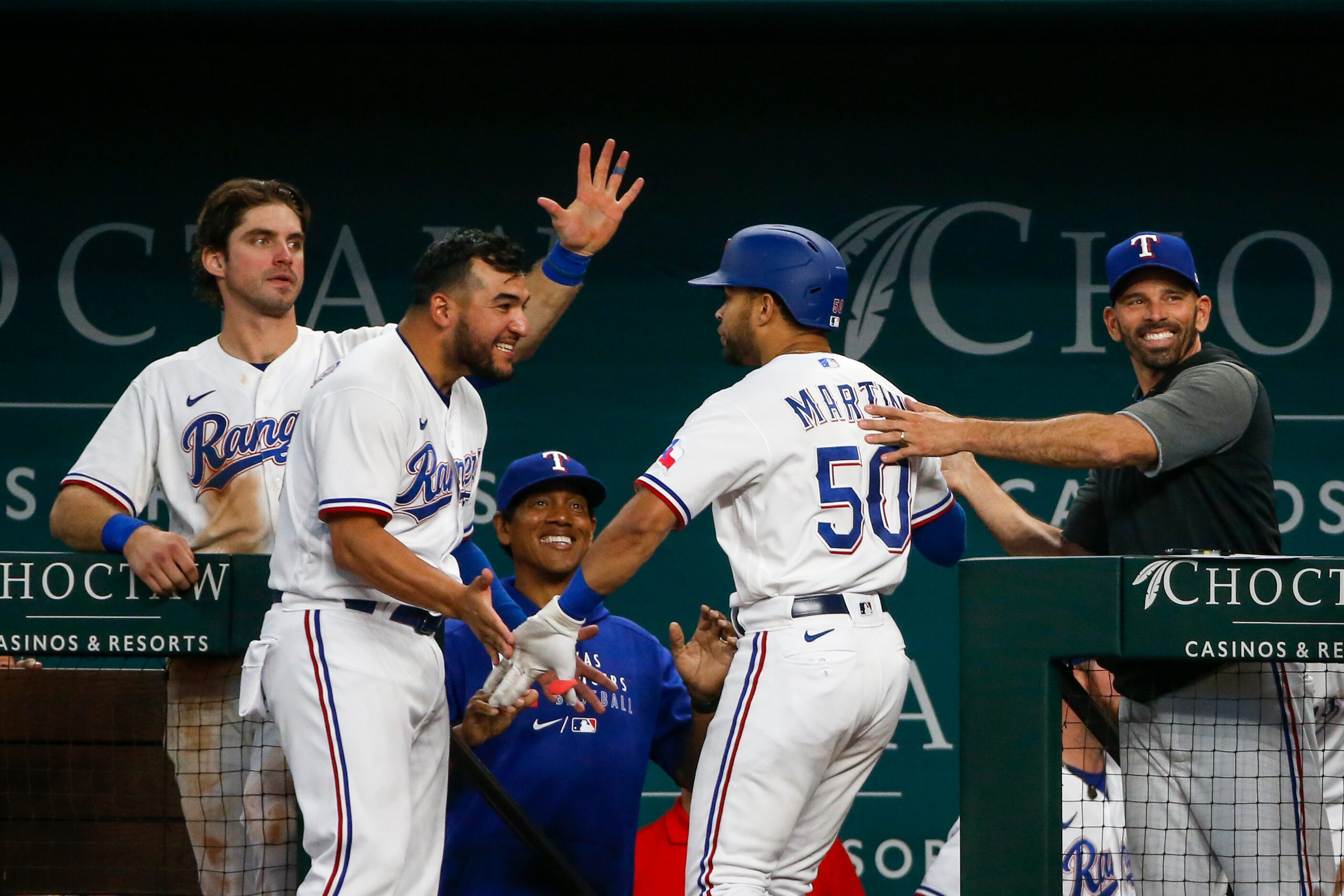 Texas Rangers catcher Jose Trevino (23, left) and Texas Rangers manager Chris Woodward (8)...