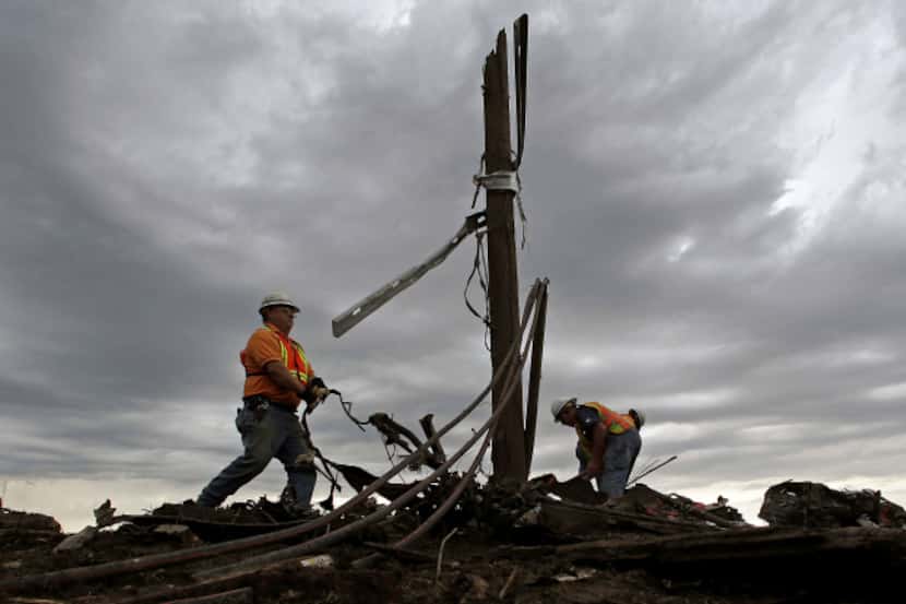 AT&T employees sorted through tangled phone lines as they worked to restore service in a...