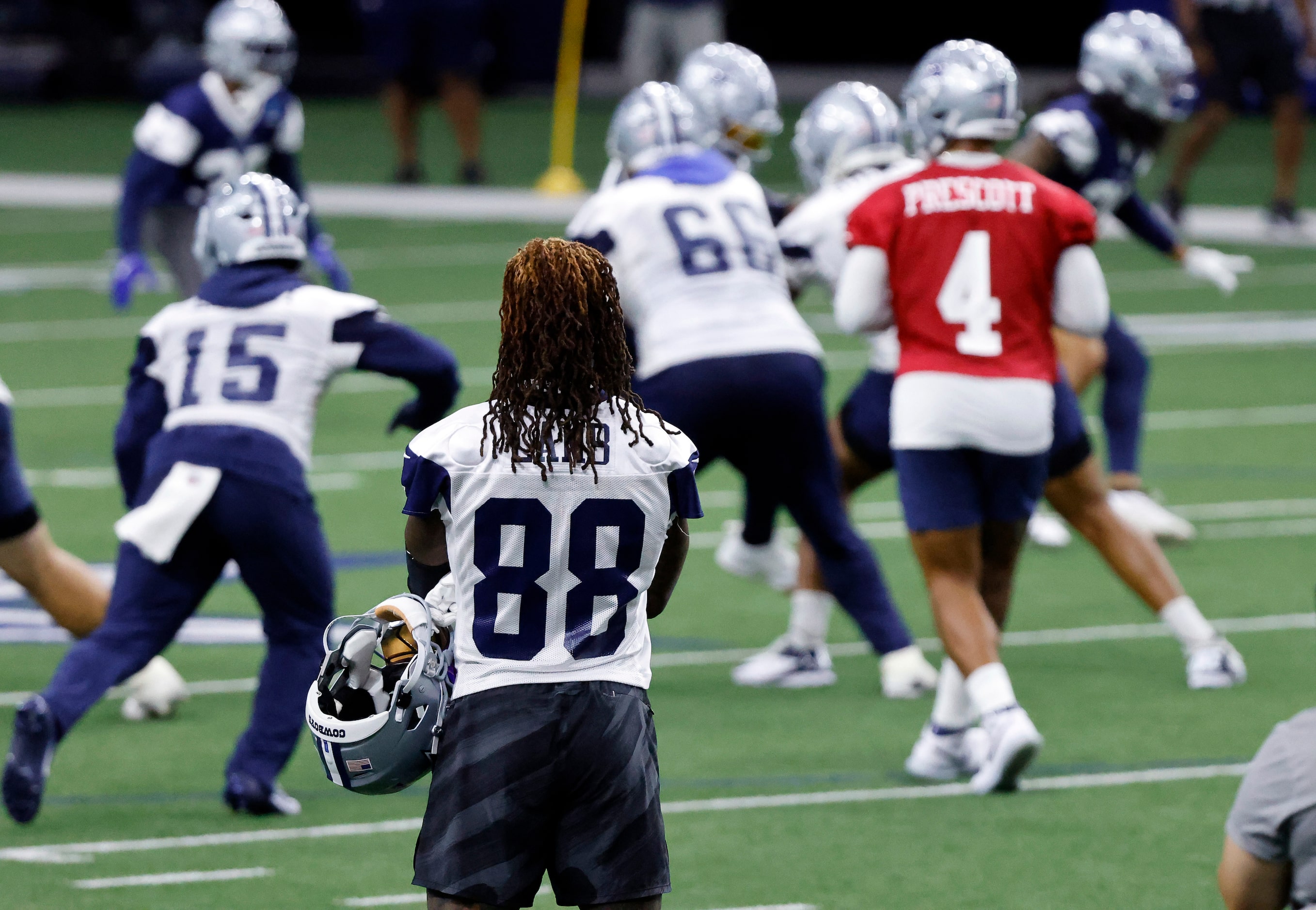 Dallas Cowboys wide receiver CeeDee Lamb (88) watches as the first team, including...