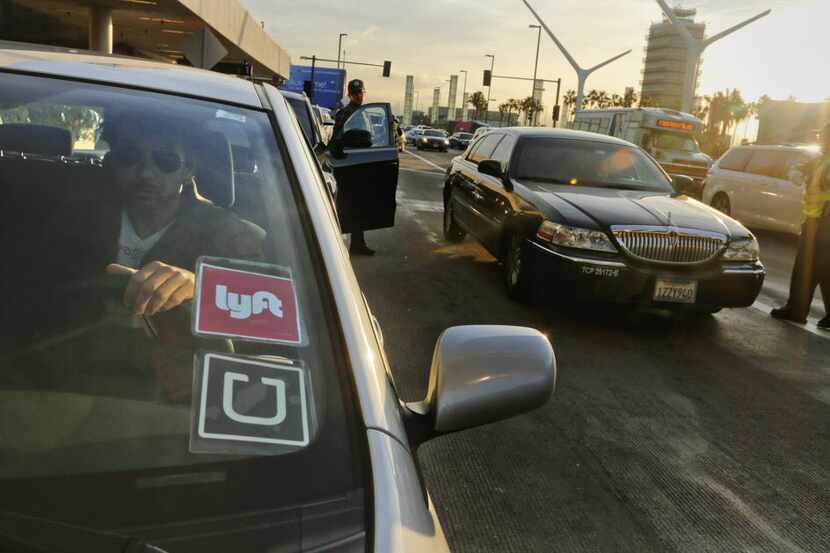 Many Lyft drivers are doubling their efforts as Uber drivers while they drop off riders in...
