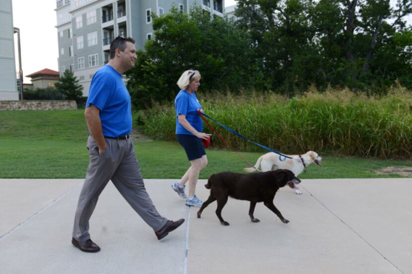Kathy Latinis walks her two pooches, Lilly and Harley, with Michael Walenciak on the Watters...