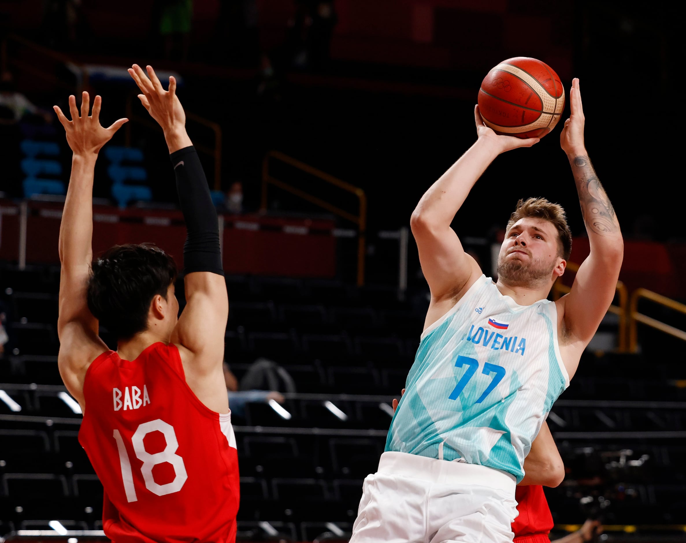 Slovenia’s Luka Doncic (77)  draws the foul as he is defended by Japan’s Yudai Baba (18) and...