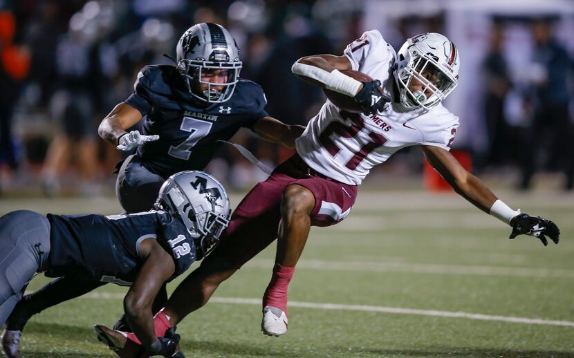 Arlington Martin senior linebacker Jonathon Okate (12) tackles Lewisville sophomore running...