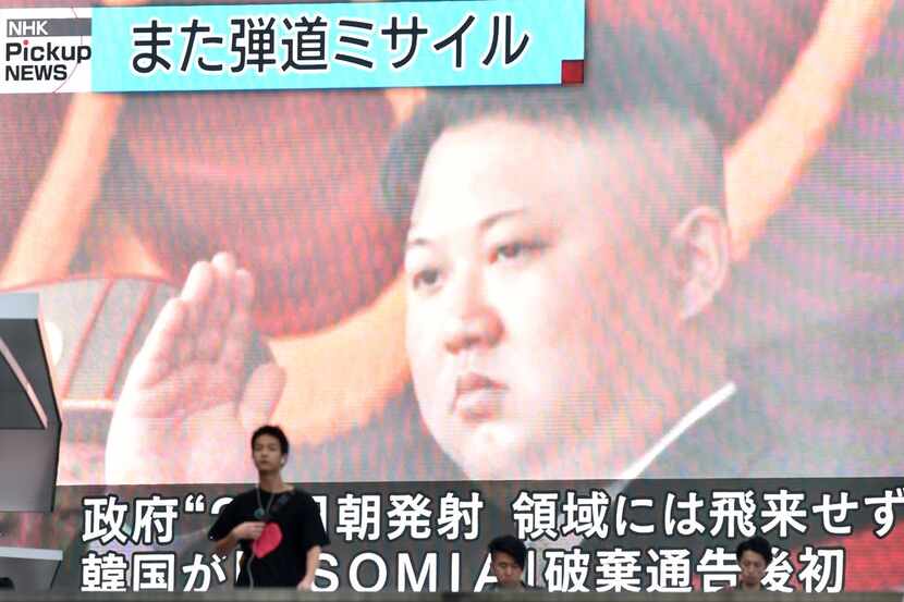 Footage of North Korea's leader Kim Jong Un is seen on a giant television screen in Tokyo on...