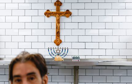 The first piece of bagel that came out of the oven sits under a crucifix at Sclafani's,...
