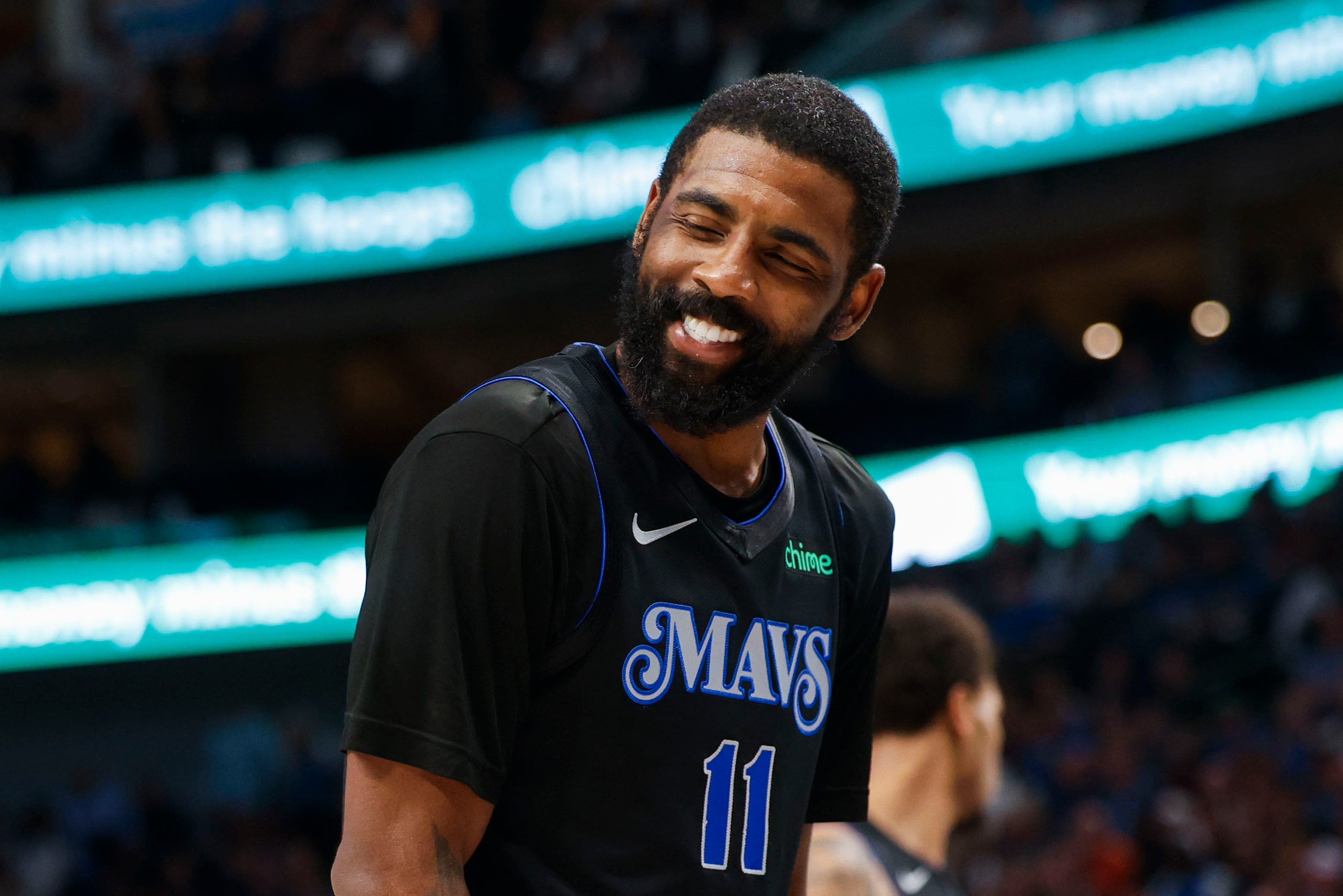 Dallas Mavericks guard Kyrie Irving reacts towards the bench during the second half of an...