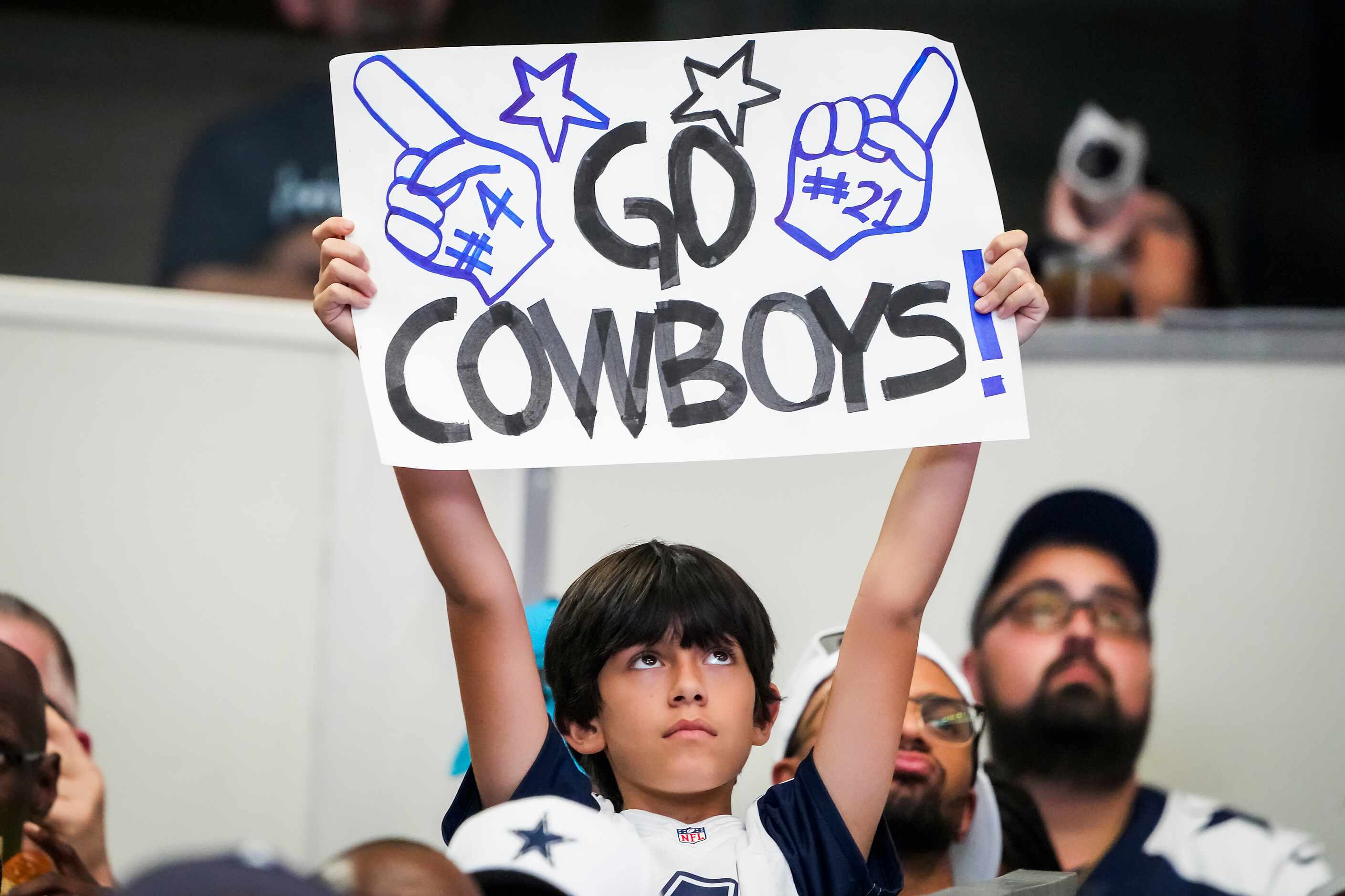 Dallas Cowboys fans celebrate a Cowboys score during the third quarter of an NFL football...