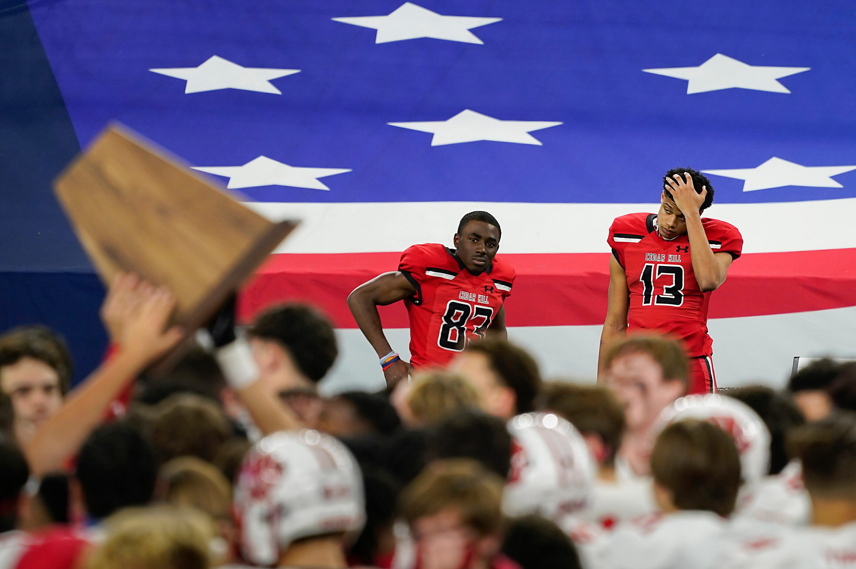 Cedar Hill wide receivers Javien Clemmer (13) and  Felton Brisco (83) watch from the bench...