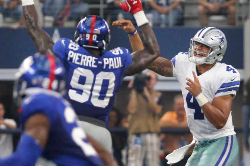 Dallas Cowboys quarterback Dak Prescott (4) throws a pass as New York Giants defensive end...