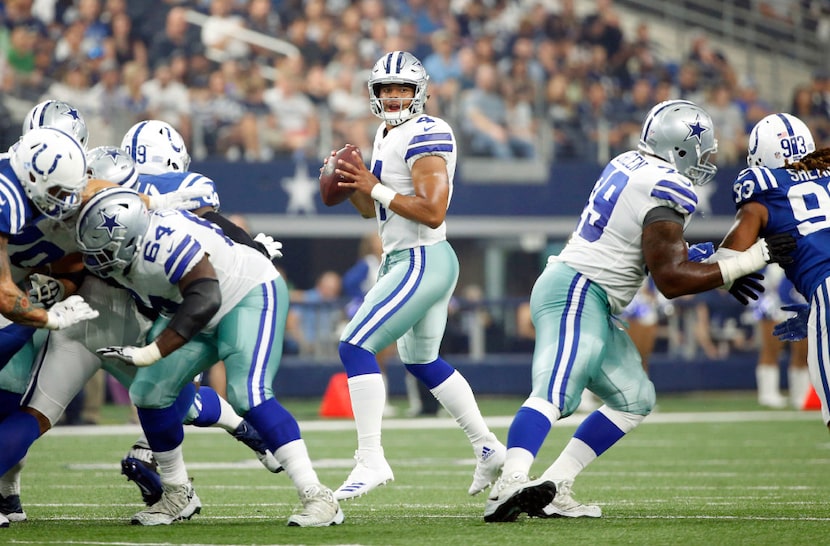 Dak Prescott (4) looks for an open receiver during the first half of a preseason game...