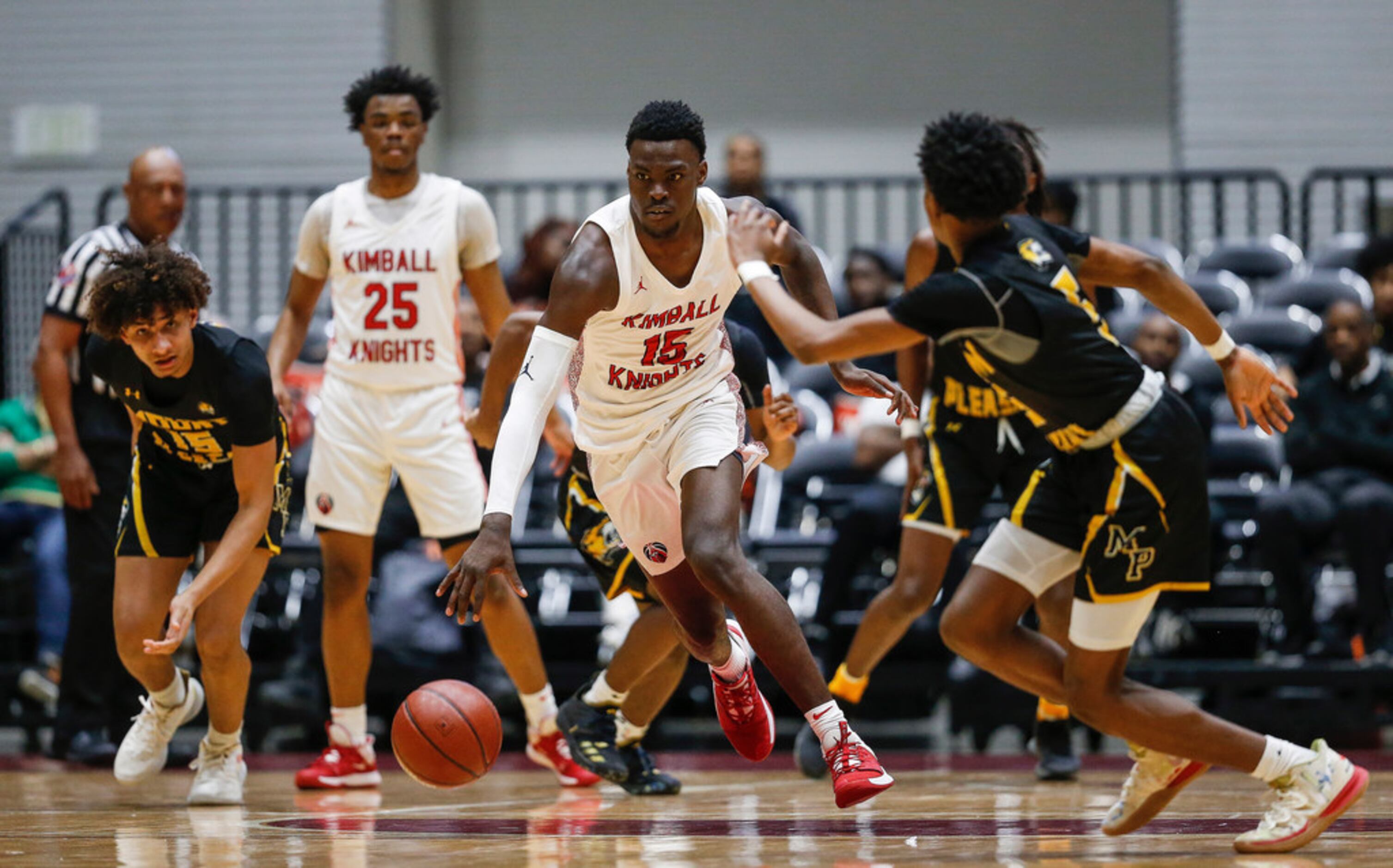 Kimball's Kyron Henderson (15) drives during the second half of a boys basketball UIL Class...