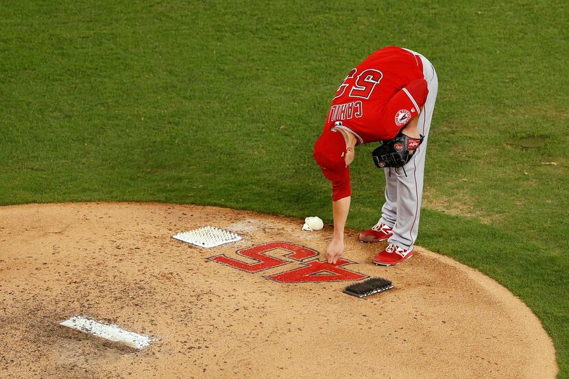 Los Angeles Angels pitcher Trevor Cahill (53) touches the number of Los Angeles Angels Tyler...