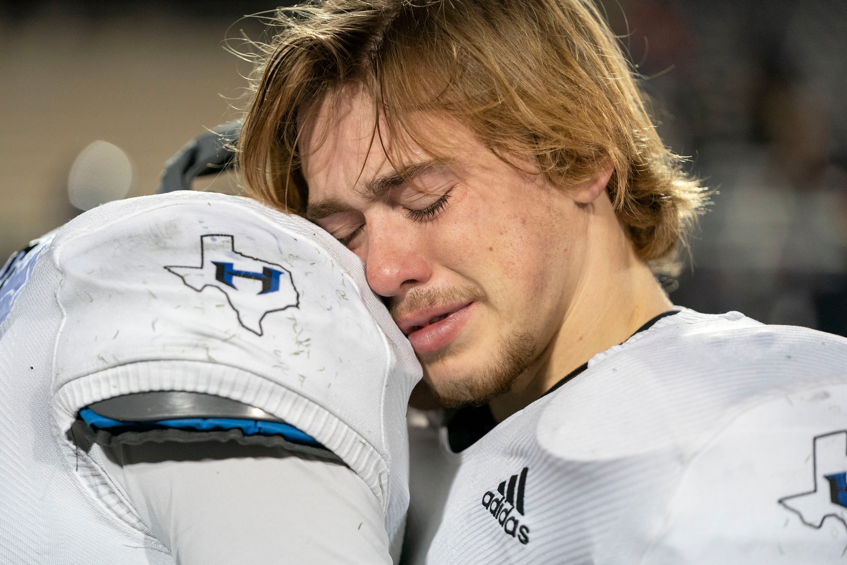 Hebron safety Matthew Howard (4) is consoled by quarterback Braxton Baker (15), right, after...