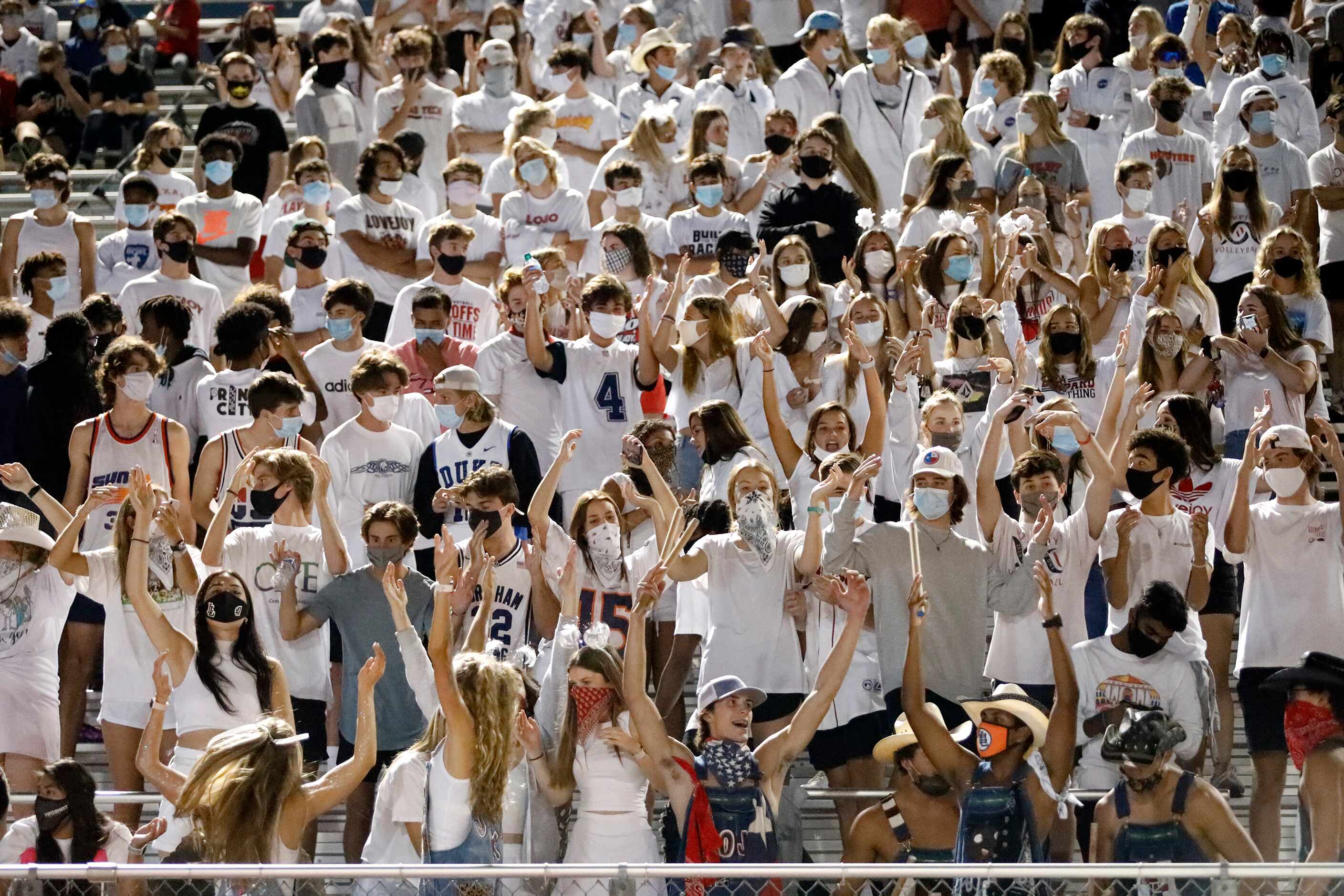 The Lovejoy High School student section cheers on their team during the first half as...