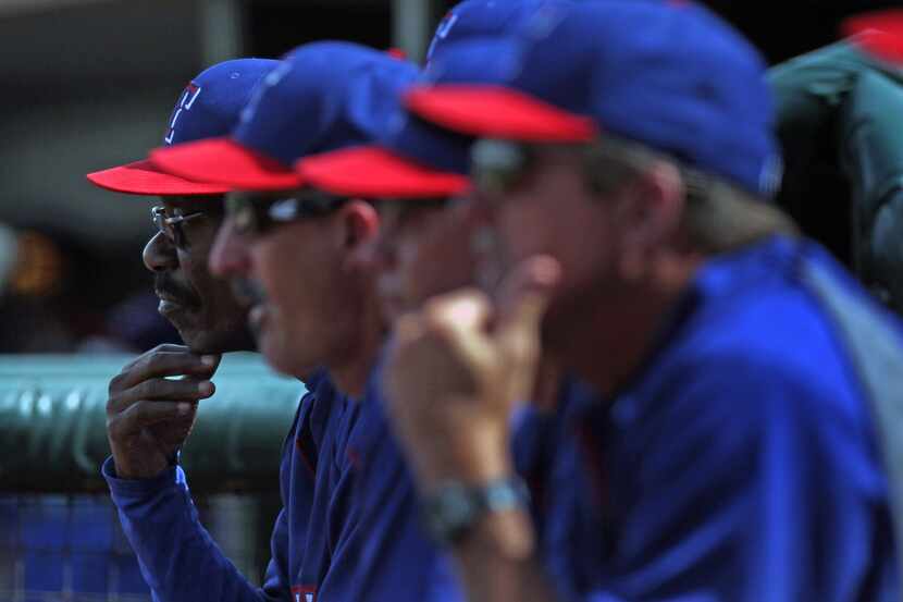 Texas Rangers manager Ron Washington (38), left, in the dugout during a spring training game...