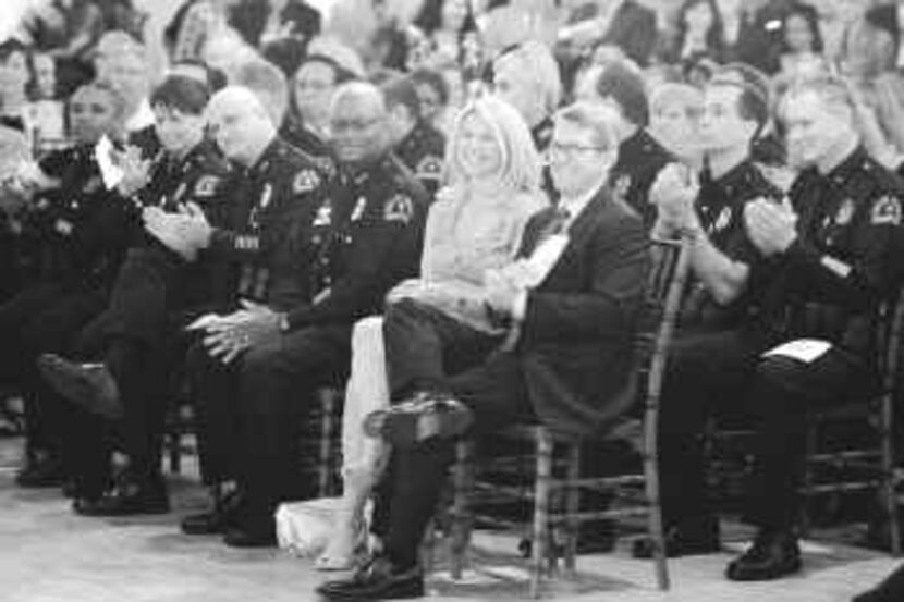  Dallas Police Chief David Kunkle and his wife, Sarah Dodd, listened to speakers at his...