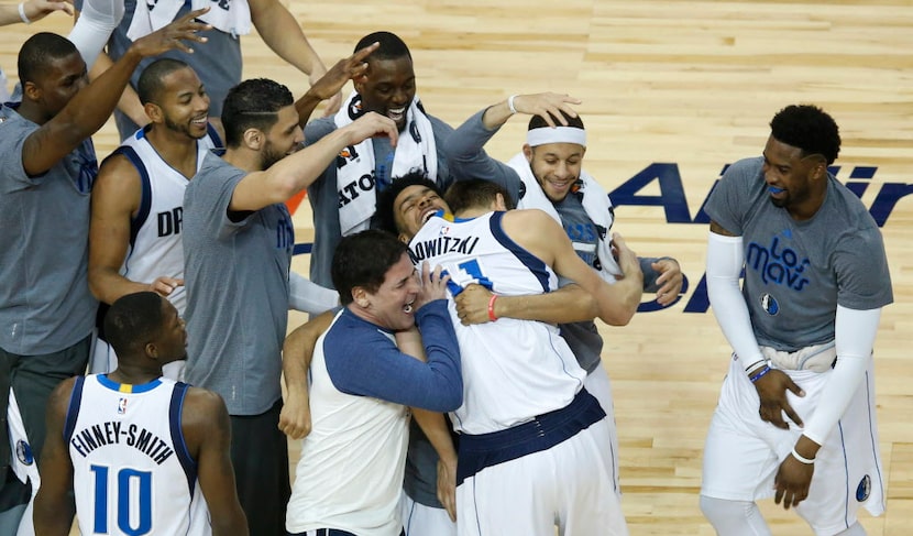 Dallas Mavericks forward Dirk Nowitzki (41) is congratulated by Dallas Mavericks teammates...