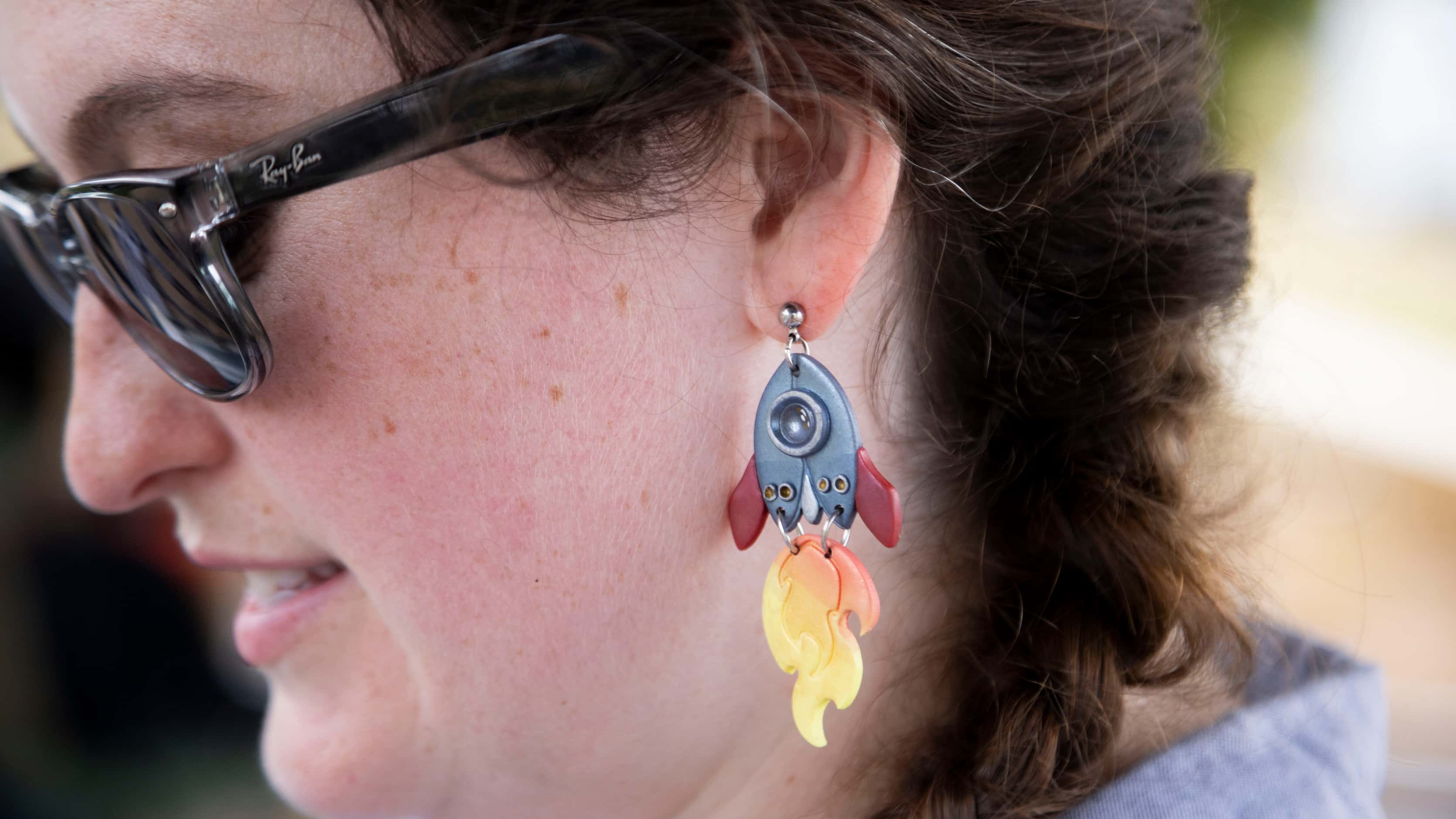 Nicole Sjoblom, partnership & outreach manager at Estes Education, wears rocket earrings...