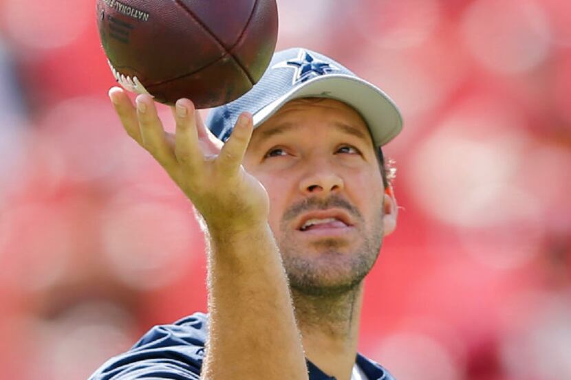 Dallas Cowboys quarterback Tony Romo (9) plays with a football before a game between the...