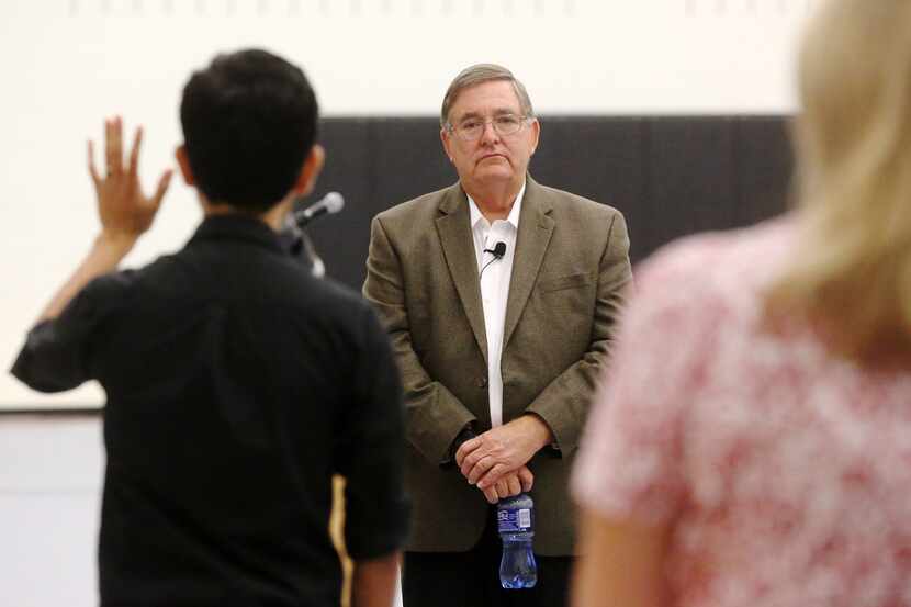 Congressman Michael Burgess listens to concerned residents during a town hall meeting at...