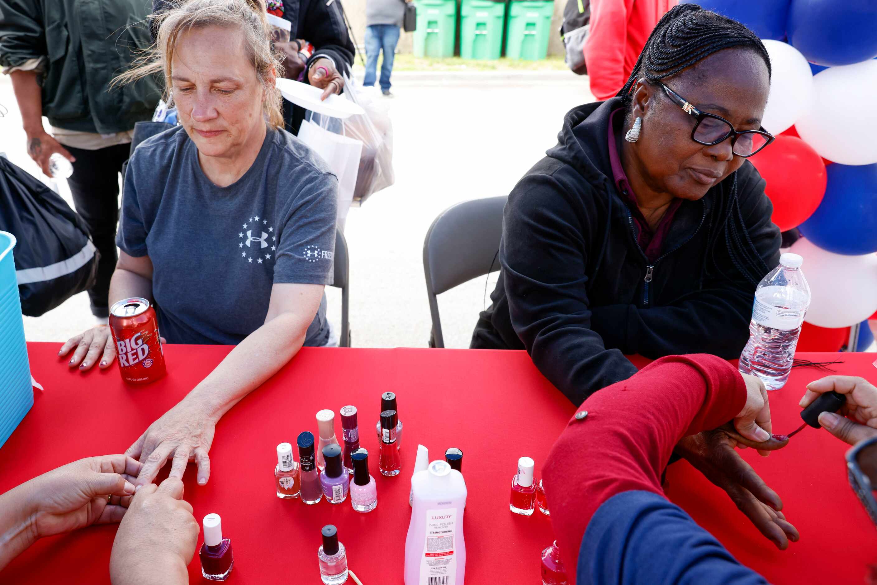 Loretta Smith (left) and Florence Ogvan gets their nails done by the members of Iglesia...